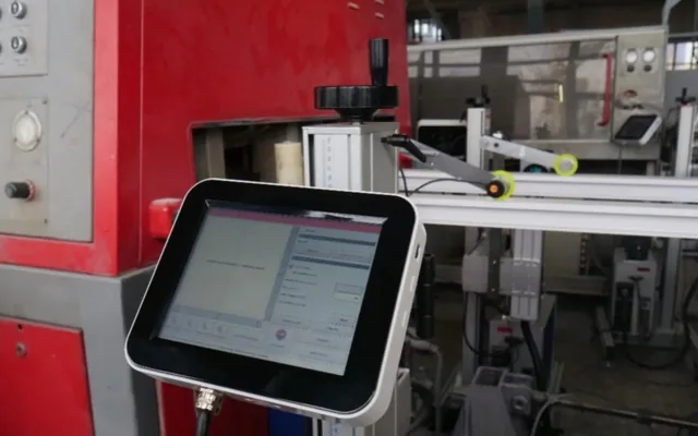 Touch panel controlling the marking station, mounted on a stand beside the line
