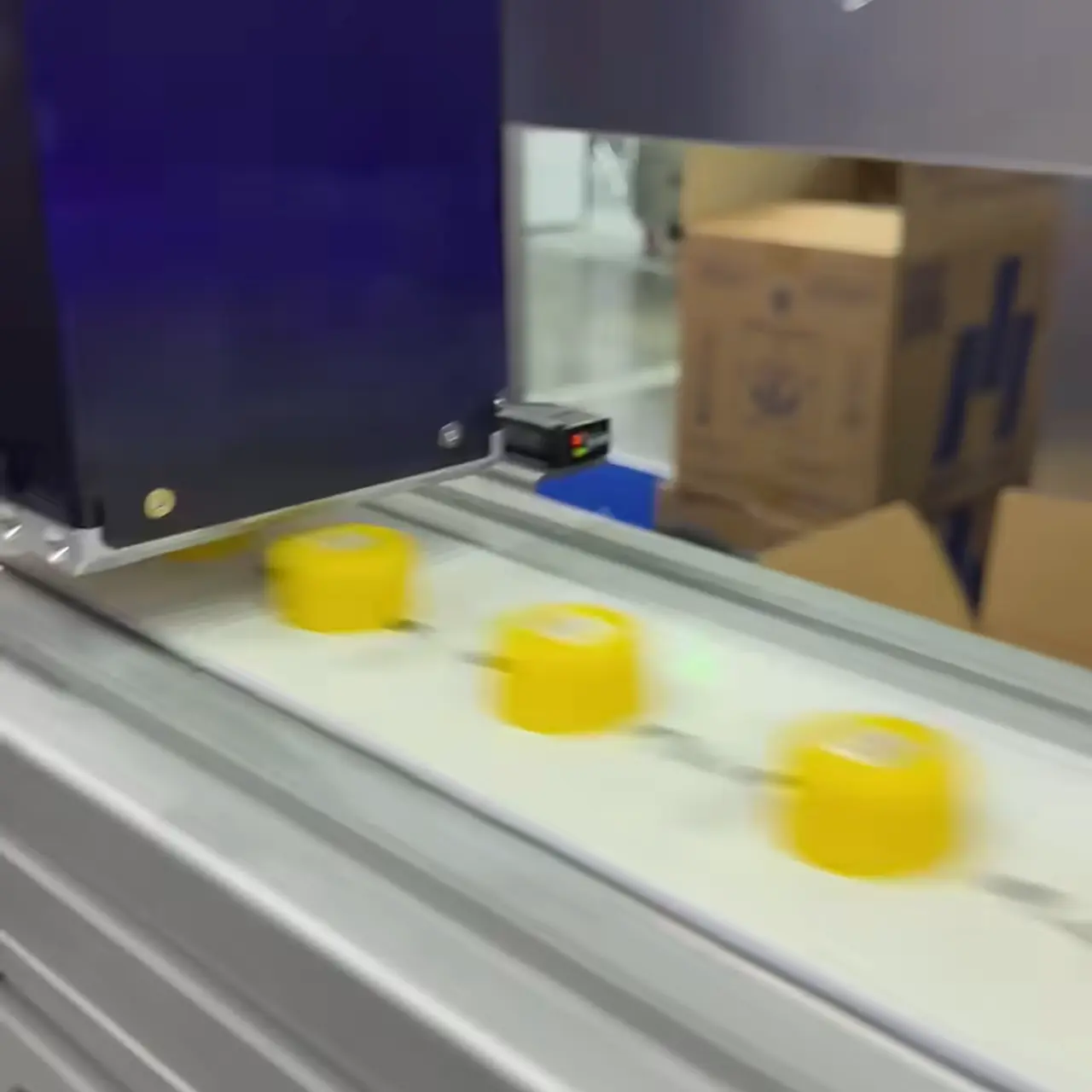Caps travel along the belt under the coding unit